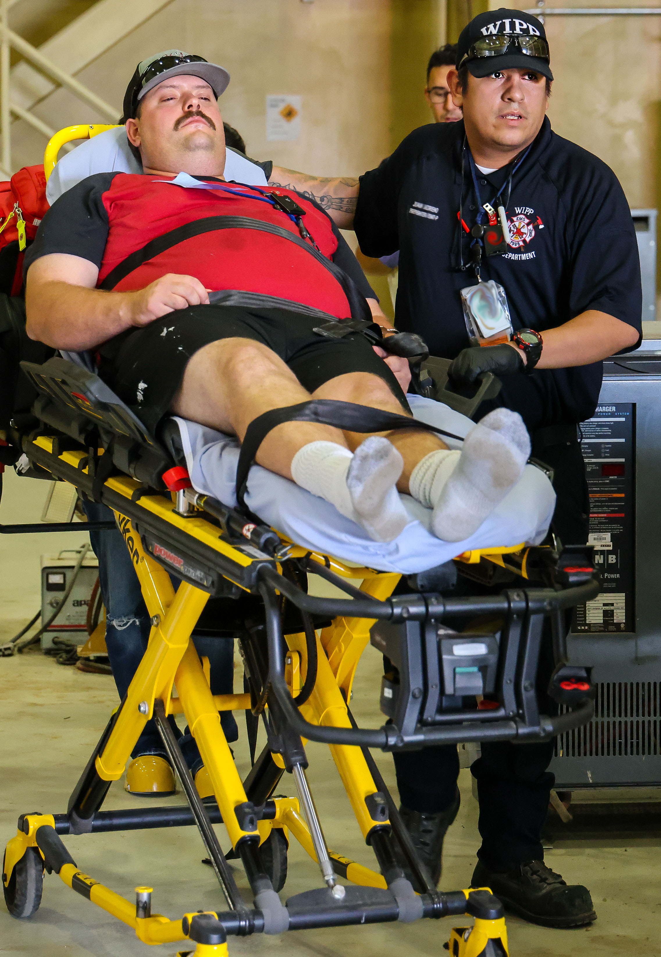 A firefighter/paramedic wheels away a victim during the exercise